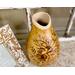 This shows the rim of the natural vase has been carved with a textured stippled effect. The rim is light beige.